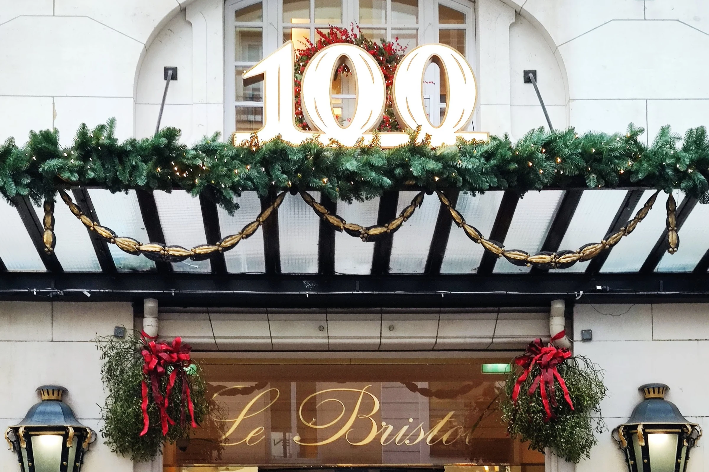 The centenary display above the entrance canopy of Le Bristol Paris